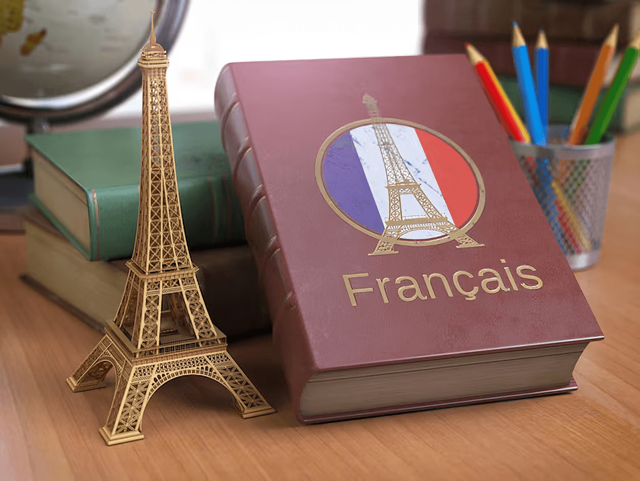 French study materials beside an Eiffel Tower model